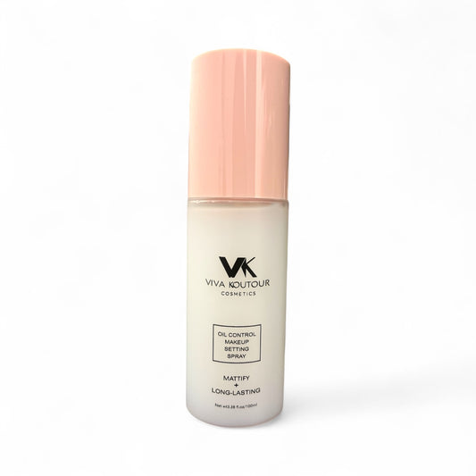 Viva Koutour makeup setting spray bottle with pink cap on a white background