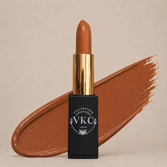 Lipstick with gold cap and black casing featuring 'VKC' branding on a beige background.