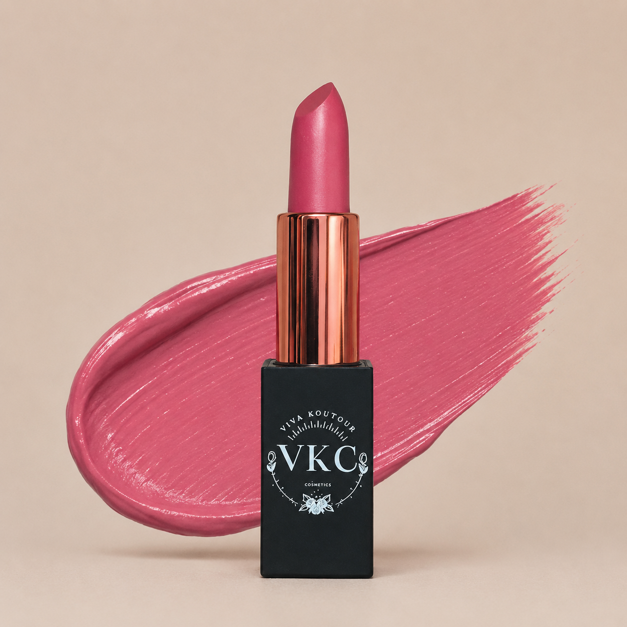 Pink lipstick with black packaging featuring 'VVKC' on a beige background