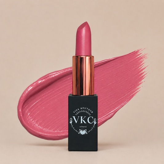Pink lipstick with black packaging featuring 'VVKC' on a beige background
